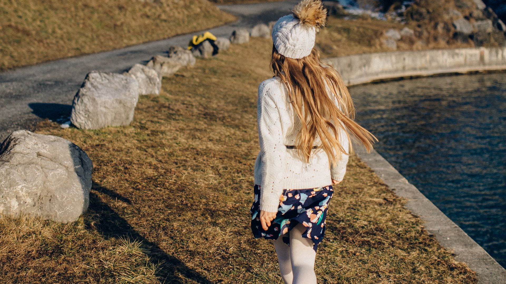 Girl walking next to a reservoir